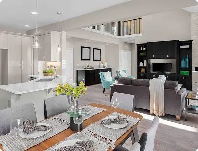 A modern kitchen and dining area seamlessly connected to a stylish living room, showcasing contemporary design elements.